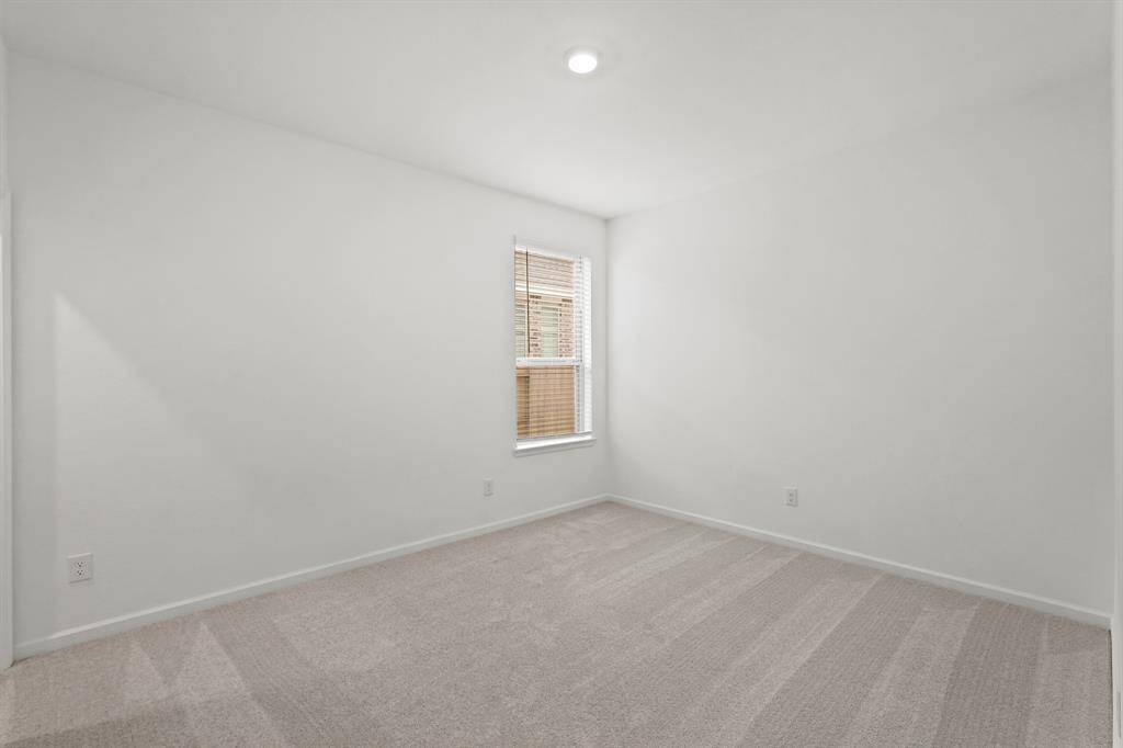Third Bedroom with plush carpet and window for additional lighting.