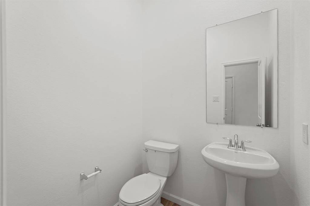 Powder Room for your guests with tile flooring and vanity.