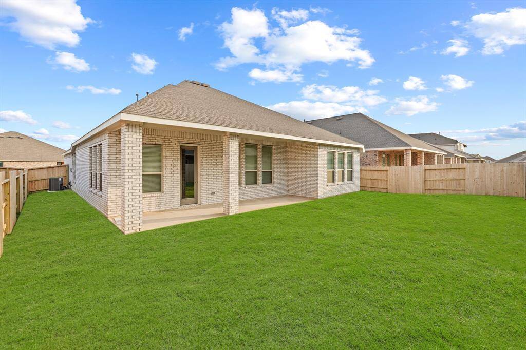 Step out back to enjoy the Charming Covered Patio, greenspace and wonderful area to entertain or play with the kids.