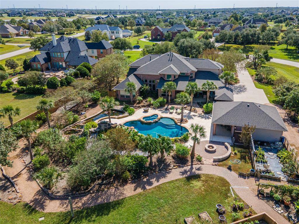 Dive into Luxury Outdoor Living. Nestled on a sprawling 1.65-acre cul-de-sac lot, this property is a private oasis boasting resort-style amenities including sparkling swimming pool (heated), rock waterslide, cascading waterfall, tanning ledge, and inviting hot tub.