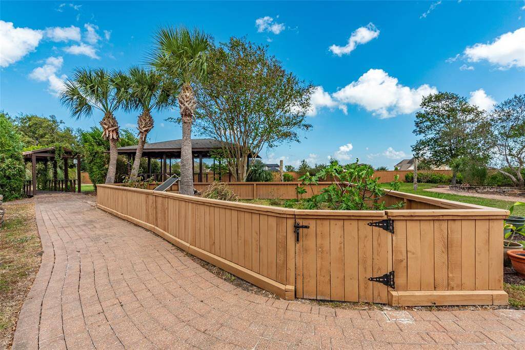 Calling All Animal Lovers!  The backyard features a thoughtfully designed gated enclosure—ideal for turtles, rabbits, or chickens—complete with natural vegetation and self-sustaining food sources.