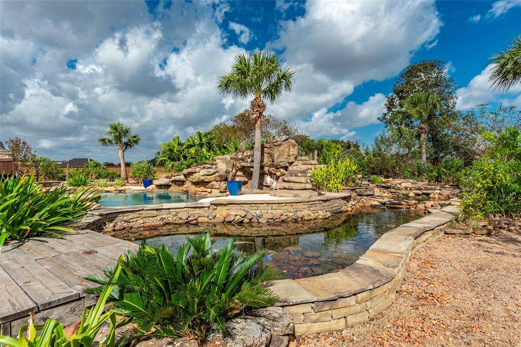 A True Outdoor Sanctuary! This property is a botanical retreat, thoughtfully landscaped with an impressive variety of shade, flowering, and fruit trees, as well as tropical palms and pollinator-friendly plants.