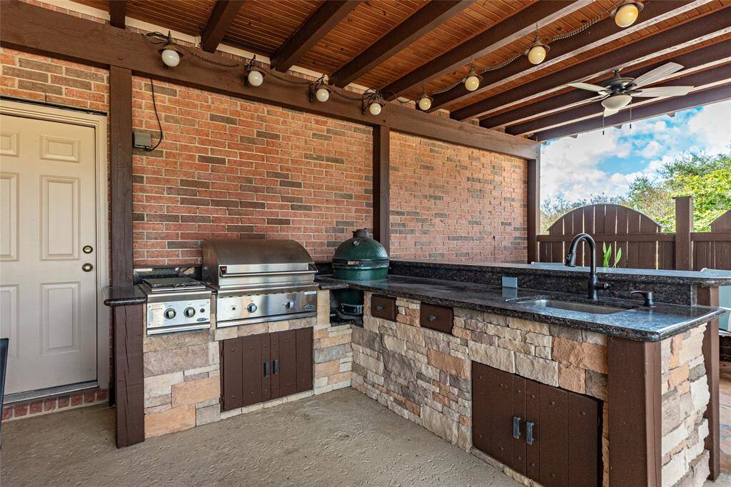 Whether you're hosting intimate evening dinners, breakfast outside or lively gatherings, this outdoor space is fully equipped to impress including an outdoor dining area and breakfast bar. A closer look reveals the outdoor kitchen designed for any chef—featuring a DCS stainless gas grill, separate side burner, Big Green Egg smoker, extensive granite for prep space/serving, sink with premium faucet, and ample built-in storage for all your tools and ingrediants.