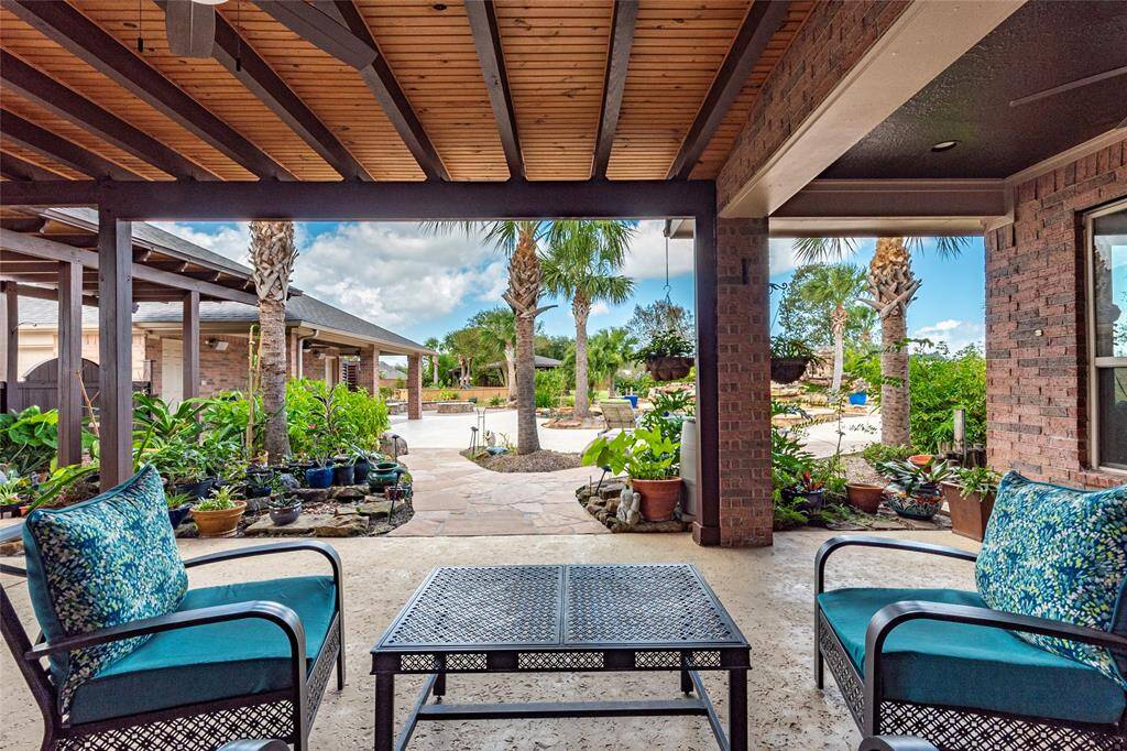 Enjoy private relaxation or effortless entertaining on the covered patio at the back of the home, complete with exterior lighting and ceiling fans for a cool, inviting atmosphere day or night.