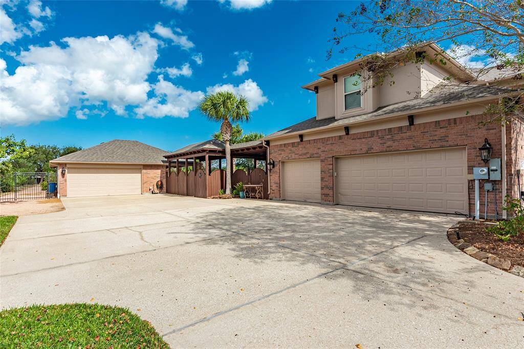 This meticulously maintained residence boasts an expansive 4,910 sq ft home and features a rare 5-car garage (3 attached, 2 detached)—perfect for car enthusiasts or multi-use flexibility. Double side gate to the left gives easy access to the backyard.
