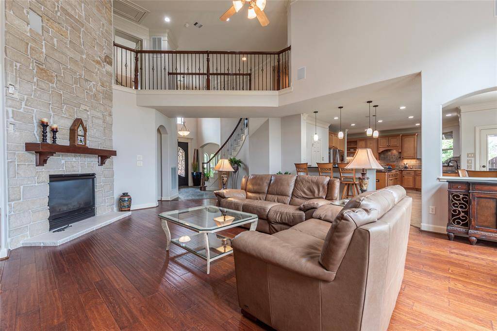 Step into the heart of this home where the family room offers a striking floor-to-ceiling limestone fireplace, creating a warm and inviting atmosphere. The stunning fireplace serves as the centerpiece, while multiple art niches throughout the room provide the perfect opportunity to showcase your personal style or unique collections. With its spacious layout and elegant details, this room is designed for both relaxation and entertaining.