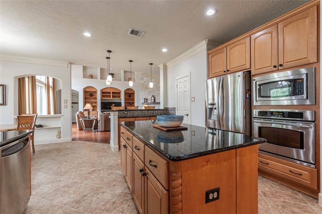 Prepare to be amazed by the expansive freshly painted kitchen featuring grand island, endless granite countertop space, perfect for meal prep and entertaining. With extensive storage, including a huge walk-in pantry with extended storage and shelving, you'll have plenty of room for all your essentials.