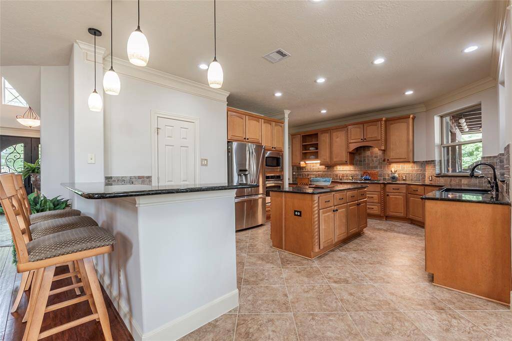 Spacious and functional, this freshly painted kitchen is designed to make busy mornings a breeze. The large breakfast bar offers a convenient spot for quick meals or casual gatherings, while the ample countertop space ensures plenty of room for preparation. With its thoughtful layout, this kitchen blends style and practicality to accommodate your daily needs