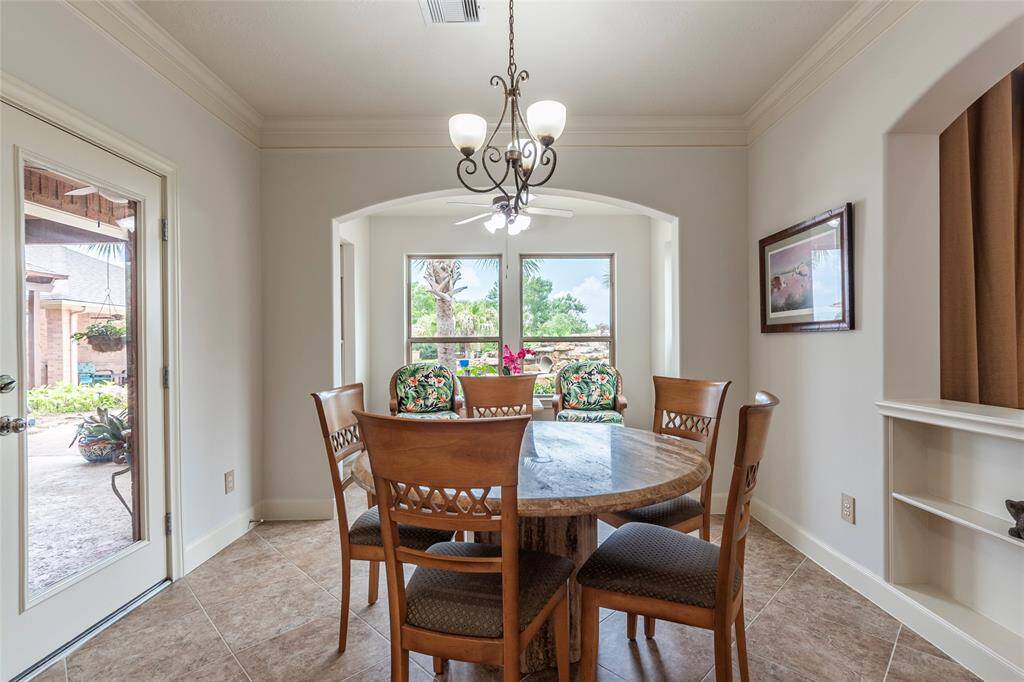 The light and bright breakfast area perfectly complements the kitchen with its open concept design. Freshly painted and filled with natural light, this charming space creates a welcoming atmosphere. Built-in storage shelves offer convenient space for organization, making it both functional and stylish for casual meals or enjoying your morning coffee.
