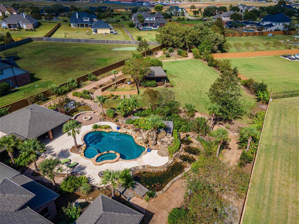Perfectly Private Entertainer! Surrounded by captivating features, this backyard oasis also includes an outdoor shower, poolside bath, and a cozy firepit. New roof installed in 2024 with Windstorm Certification.