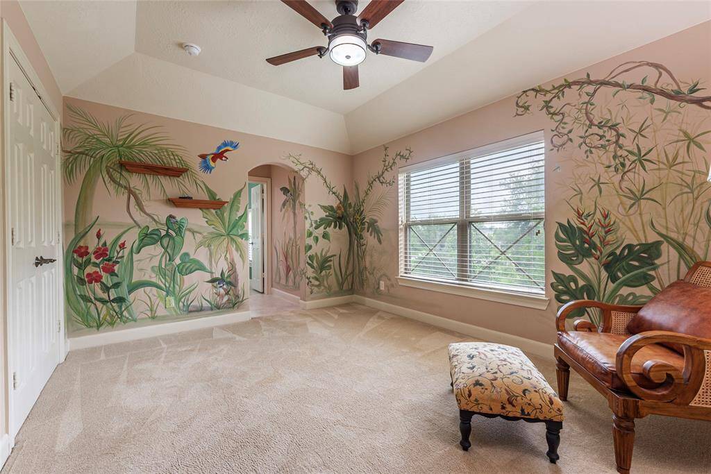 Bring the beauty of nature indoors in this spacious secondary bedroom, featuring a custom, hand-painted animal-themed mural. The room also offers a walk-in closet and connects seamlessly to the Jack and Jill bathroom, combining comfort and charm.