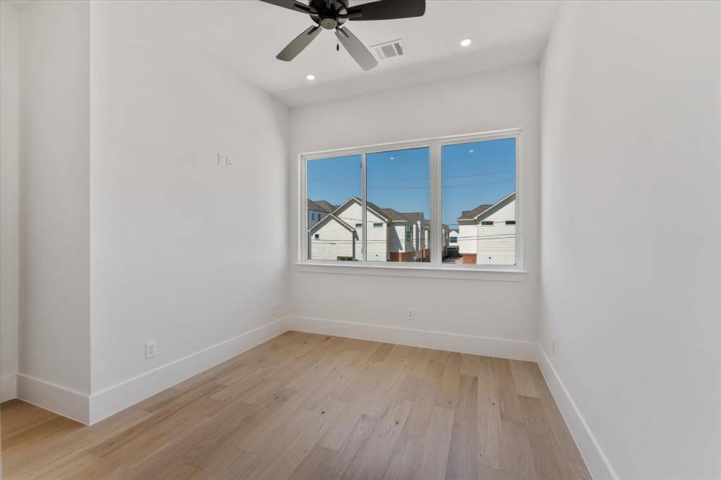 Secondary Bedroom. Flooded with natural light, oversized closet with pocketdoor.