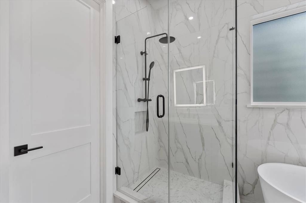 Primary Bathroom: Oversized Shower with glass enclosure.