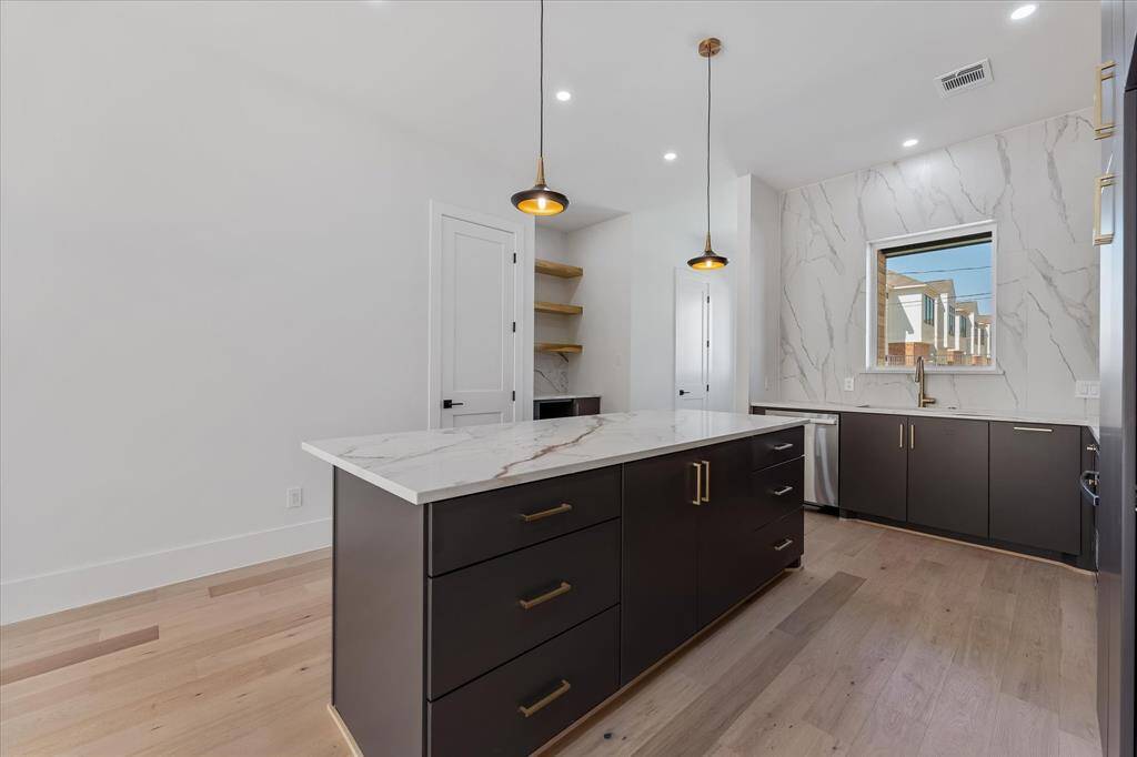 Kitchen island with CUSTOM CABINETRY! Abundant Storage - pantry door across from the island offers extra storage!