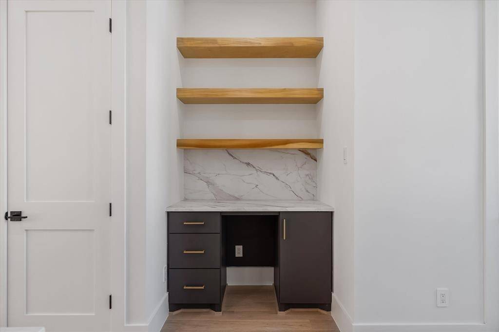 Dry Bar with space for a Wine/Mini Fridge and floating shelves. To the left, the pantry door.