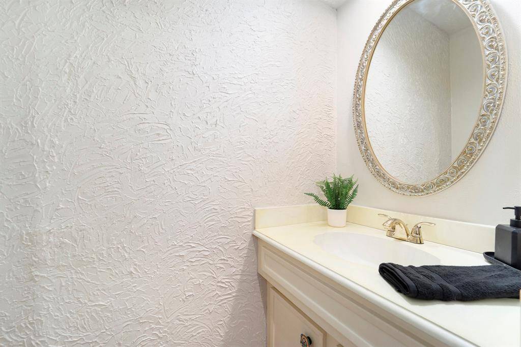 Just off the kitchen, there's a convenient half bath- perfect for guests and easy access without needing to go through the rest of the home.