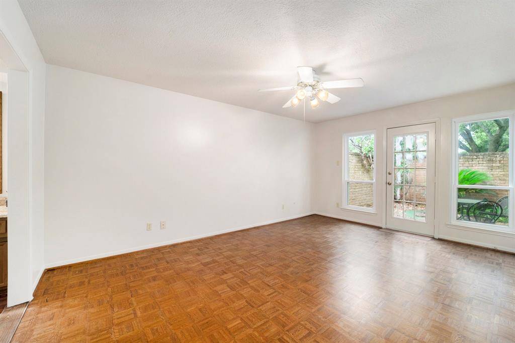 The primary bedroom is a relaxing retreat with large windows that let in soft, natural light and provide peaceful views of the private patio.  A door leads directly to the patio, giving you your own little outdoor escape- perfect for morning coffee or unwinding at the end of the day.