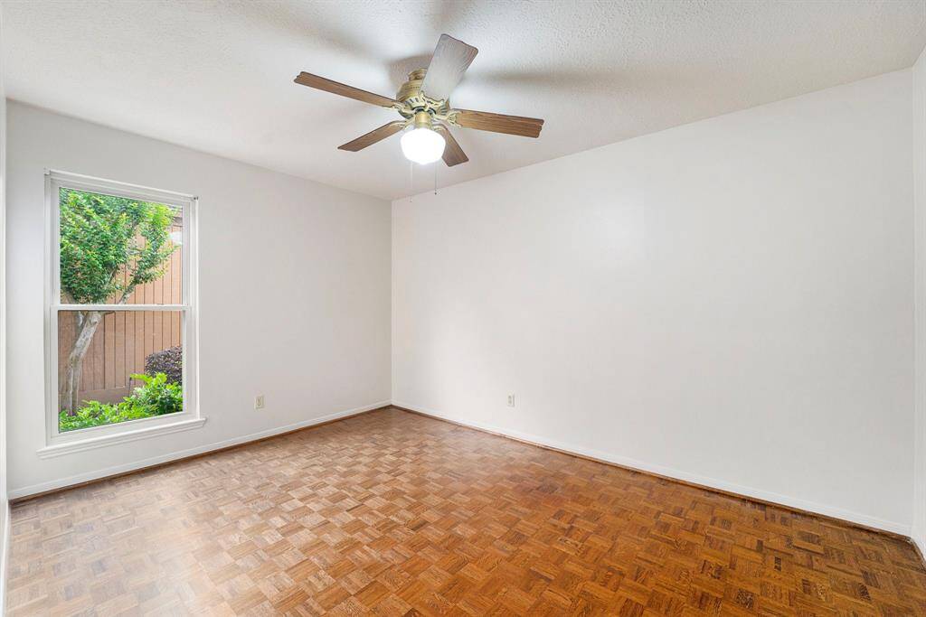 The second of two secondary bedrooms is also comfortably sized with good closet space. The window with the view of the landscaped walkway brings nature in without compromising privacy.