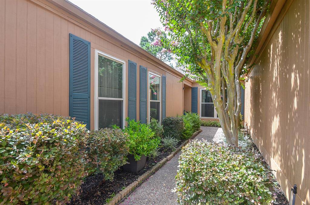 The gated, landscaped, private walkway leading to the home's entrance offers a warm welcome.