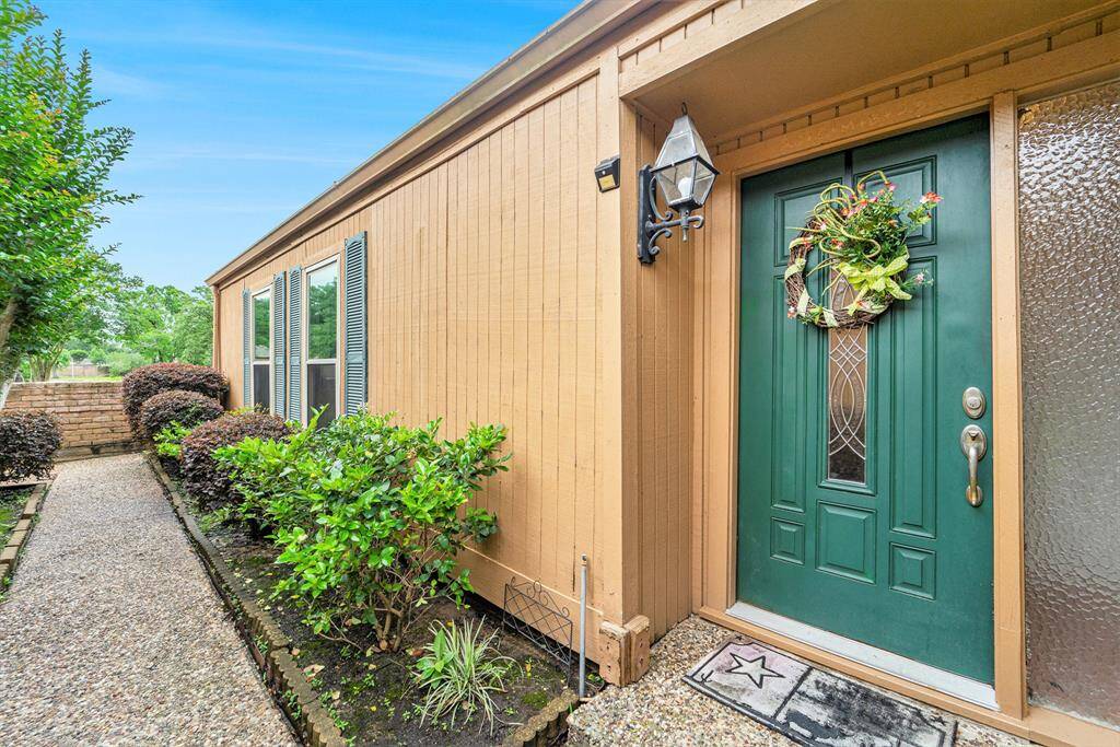The landscaped walkway creates a serene and inviting approach to the homes entrance.