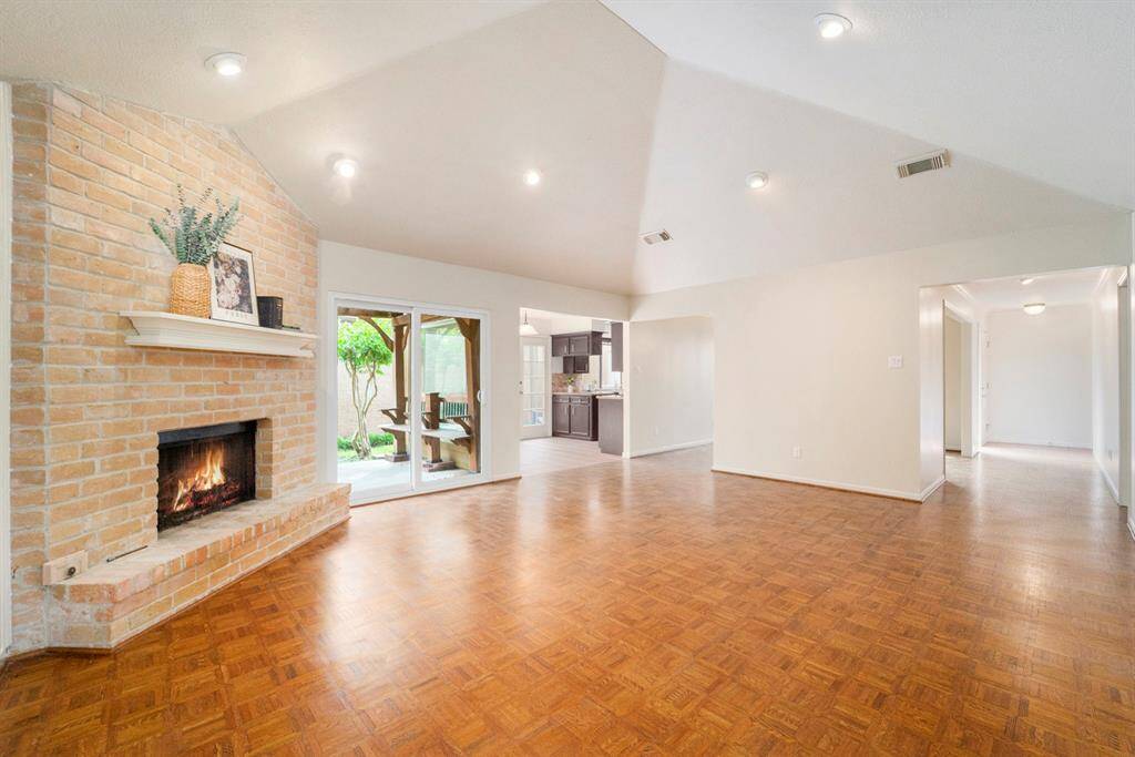 Large windows line the walls, allowing natural light to flood the room throughout the day and offering pleasant views of the landscaped exterior.