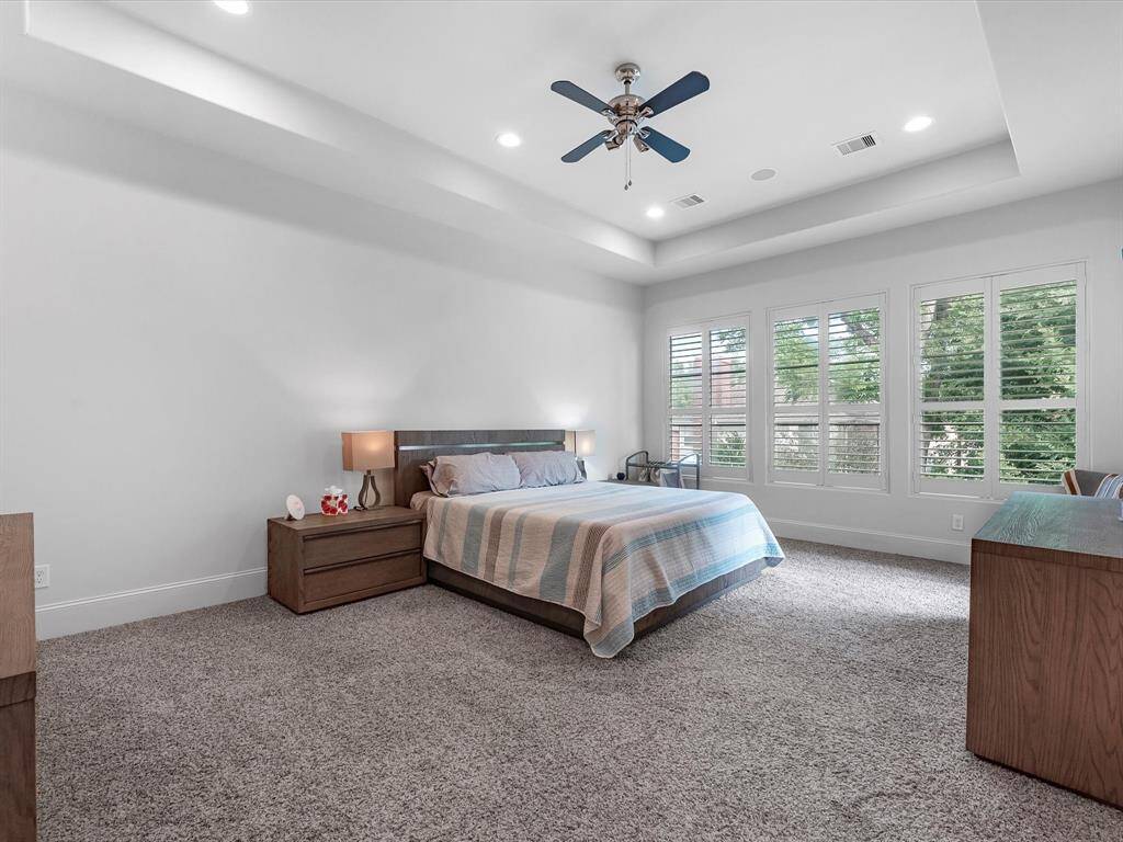 This generously sized primary bedroom offers both comfort and style. The room features beautiful crown molding, adding a touch of sophistication and character. With ample space for your furniture and a cozy sitting area, this room creates the perfect retreat. Large windows provide natural light, enhancing the inviting atmosphere, making it a true sanctuary to unwind and relax.