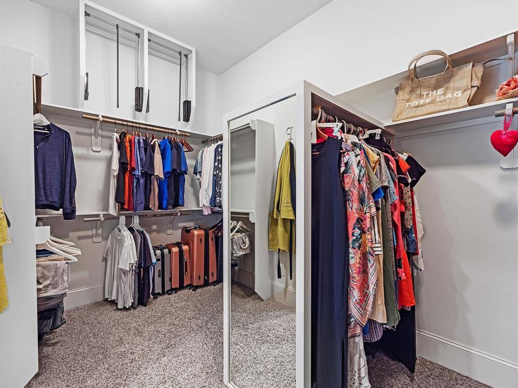 Enjoy the ultimate in organization and luxury with this stunning closet, offering generous space for your wardrobe needs. The ample storage, shelving, and hanging areas provide a perfect blend of functionality and style.