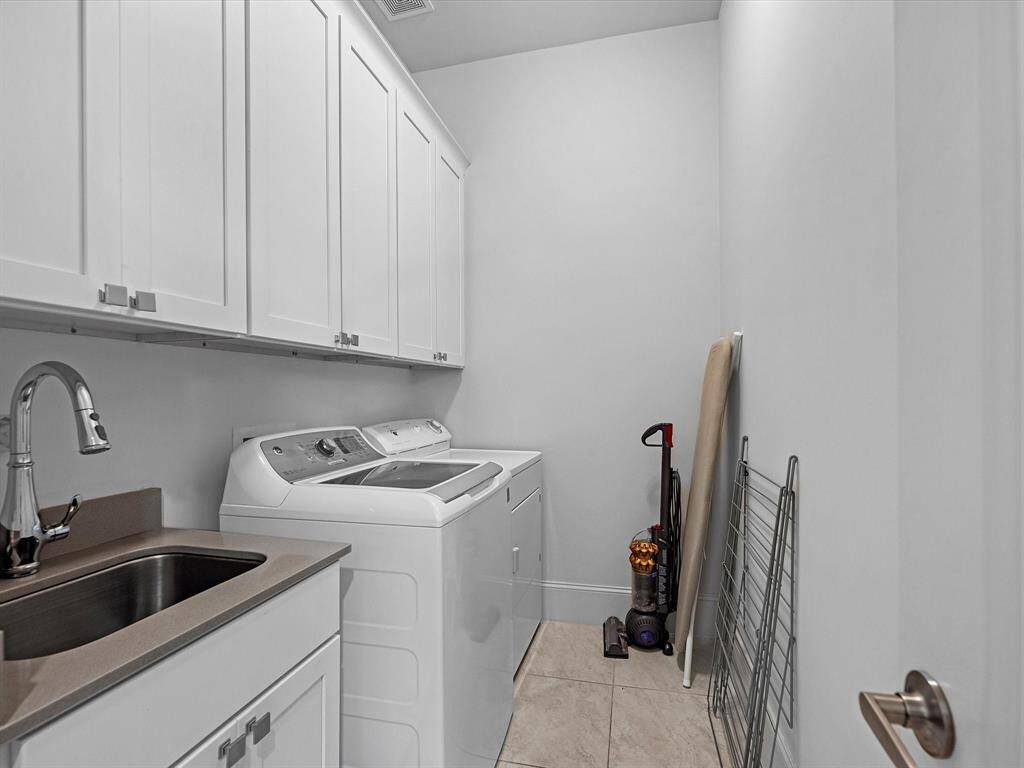 The laundry room features a sink and is convenient for the bedrooms offering functionality.