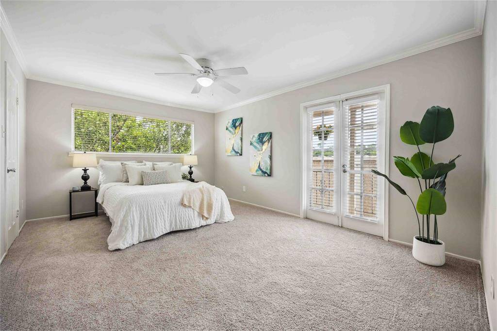 The primary bedroom en suite offers access to a private balcony.