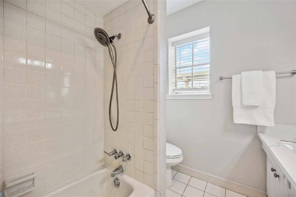 The secondary full bath also features a tub and shower combination.