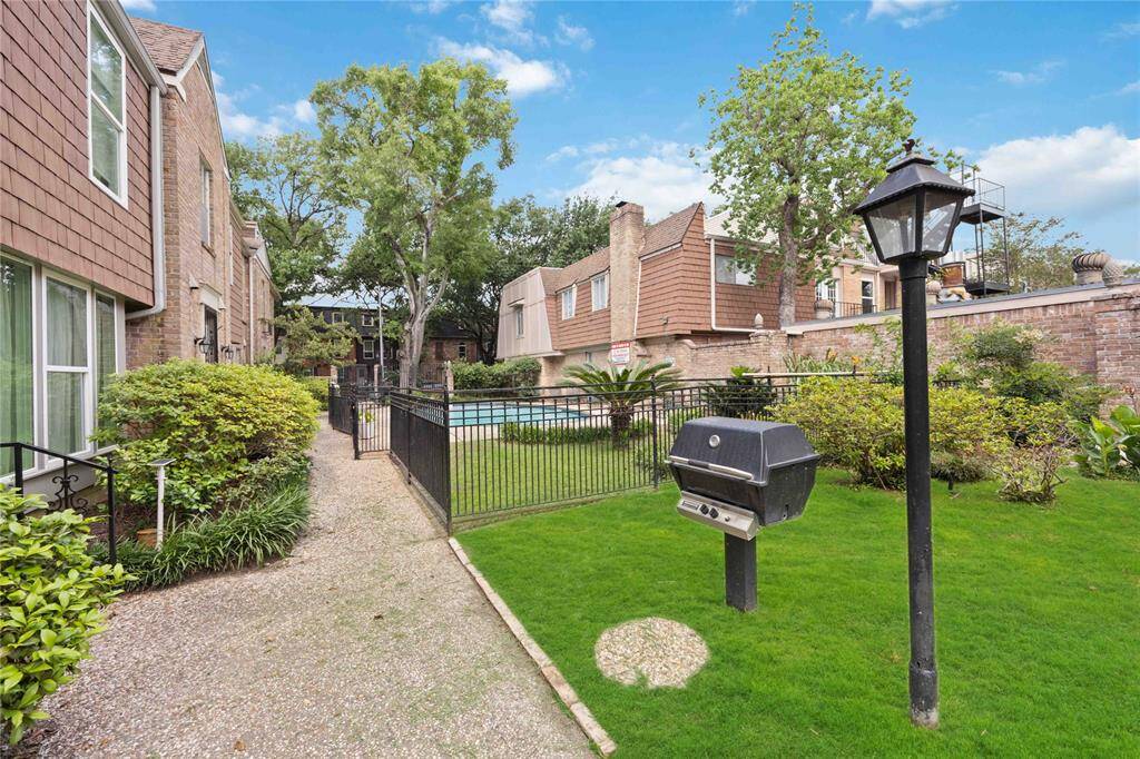 A lovely courtyard area is home to a community pool and a green space. Notice the built-in grill!