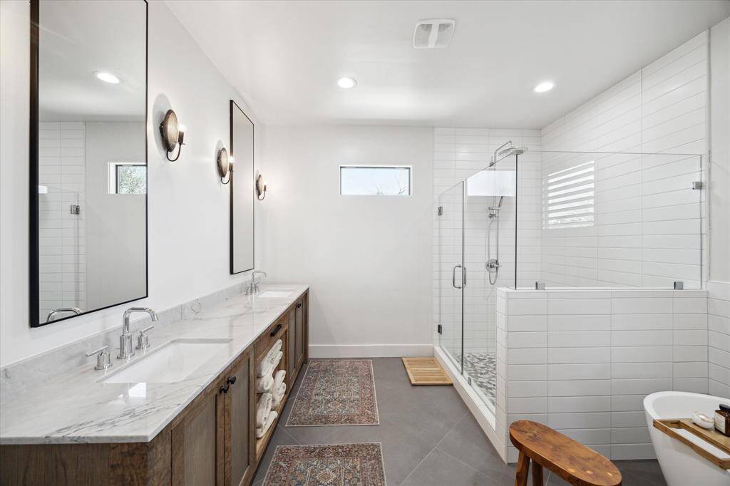 Spa-like primary bath, with modern finishes. Dual sinks, separate shower, and soaking tub.
