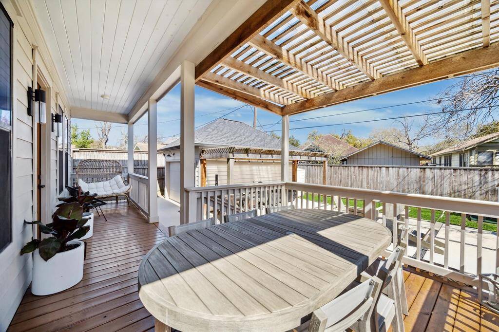 Covered back porch with plenty of space for outdoor dining.