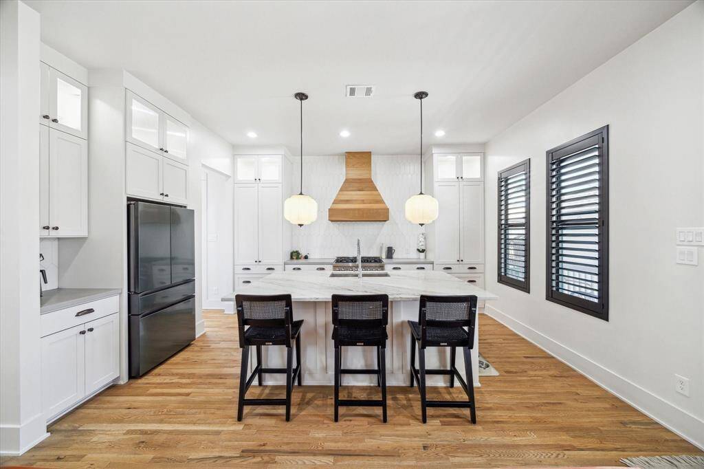 The eat-in kitchen has so many great features. Custom designed cabinetry includes soft close pots and pans drawers, slide out storage. Plenty of storage! Walk-in pantry and so much more.