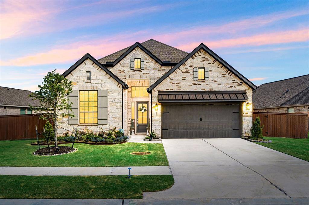 Charming brick and stone elevation with lush landscaping and great curb appeal