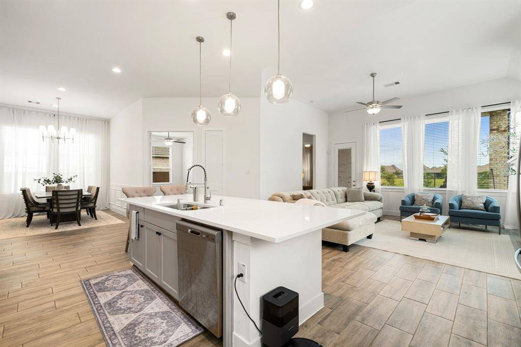 Modern kitchen with quartz countertops, stainless appliances, and a large island.