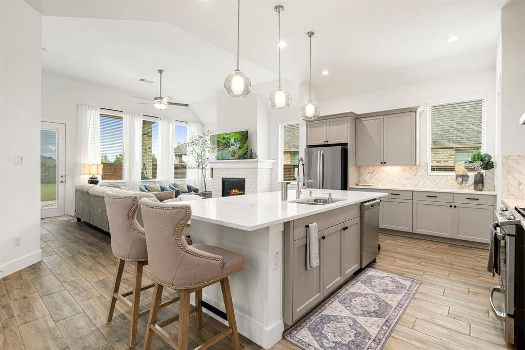 Gather around the oversized island with barstool seating—perfect for casual meals.
