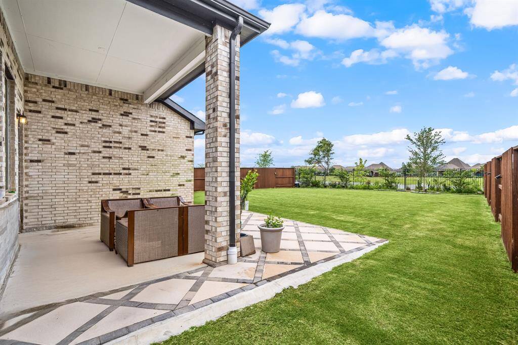 Spacious backyard overlooking the tranquil water—perfect for outdoor living.