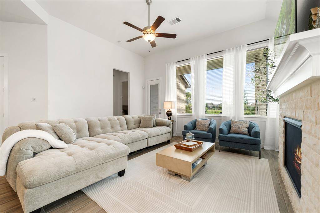 Spacious living room with large windows and a cozy fireplace.