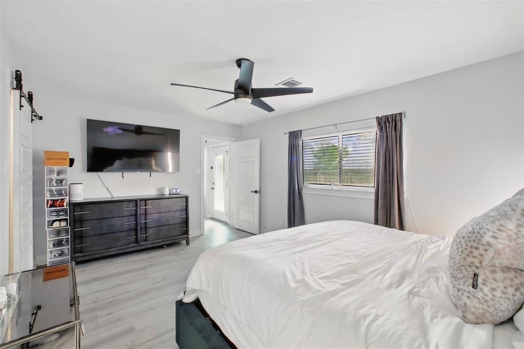 Primary Bedroom with Sliding Barn Door leading into Walk-In Closet