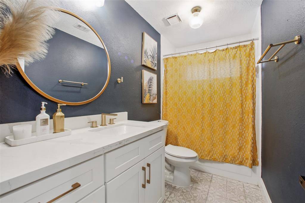 Secondary Bathroom complete with tile flooring & Quartz Vanity