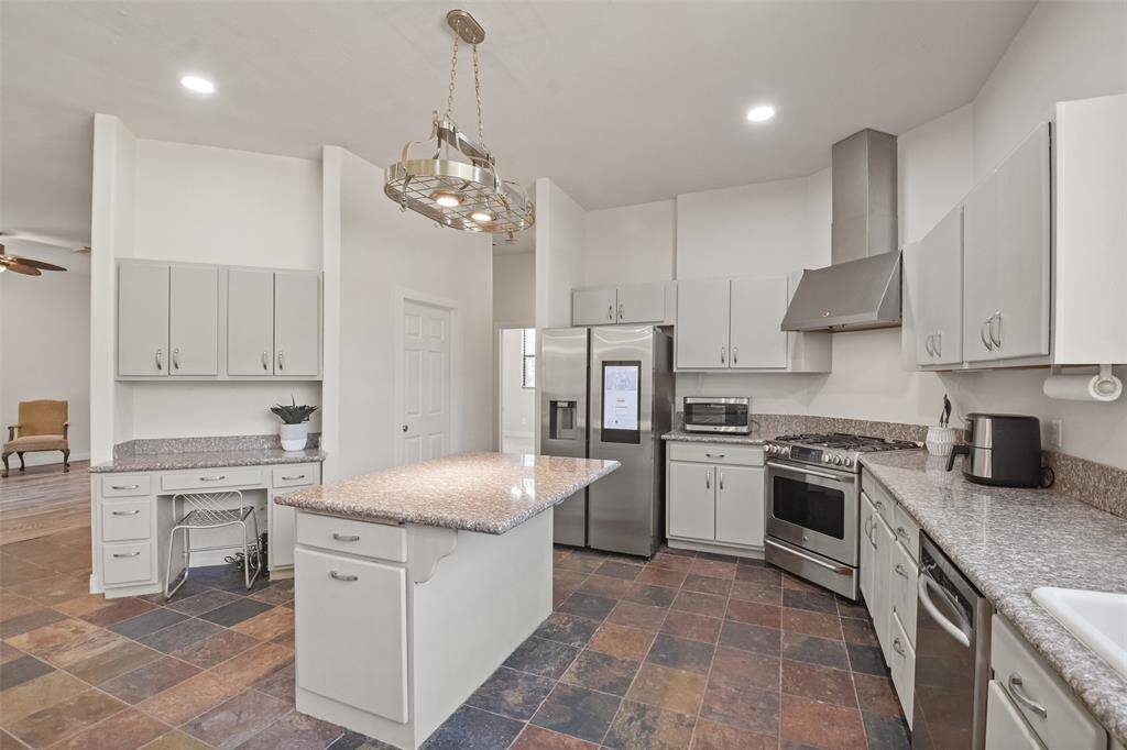 The kitchen has upgraded stainless steel appliances and painted cabinetry that adds a contemporary feel.