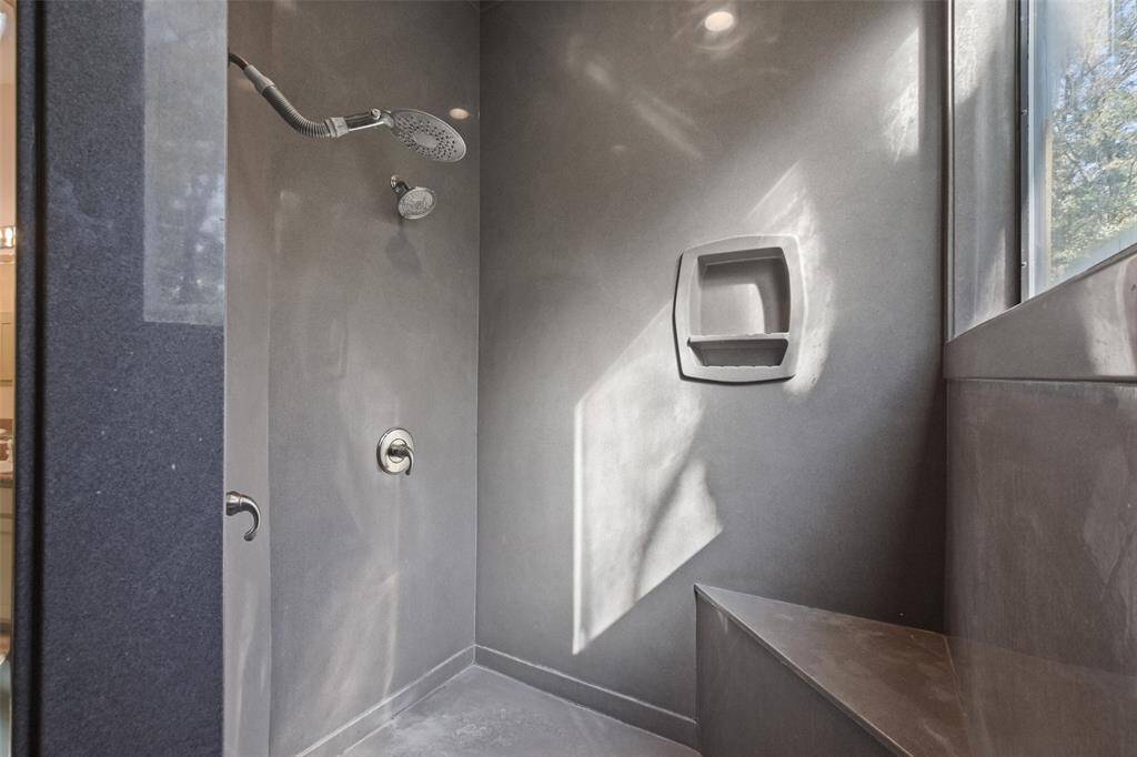 Large walk-in shower with dual shower heads.