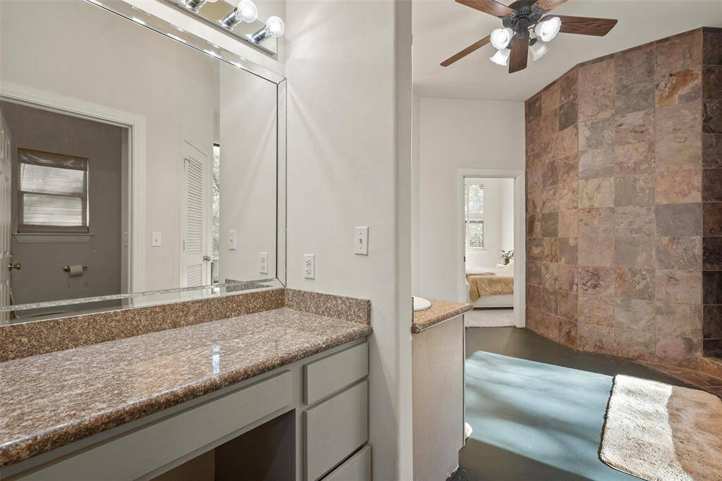 The primary bath has a dual-sink vanity as well as this separate vanity with room for a chair.