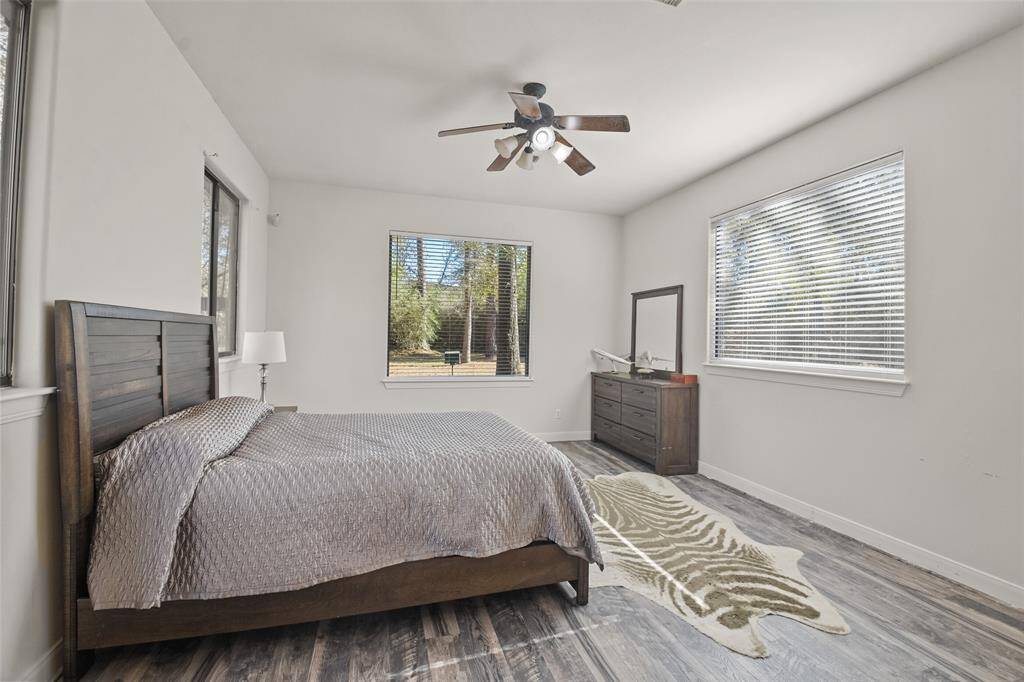 Bright & airy guest bedroom with large windows.