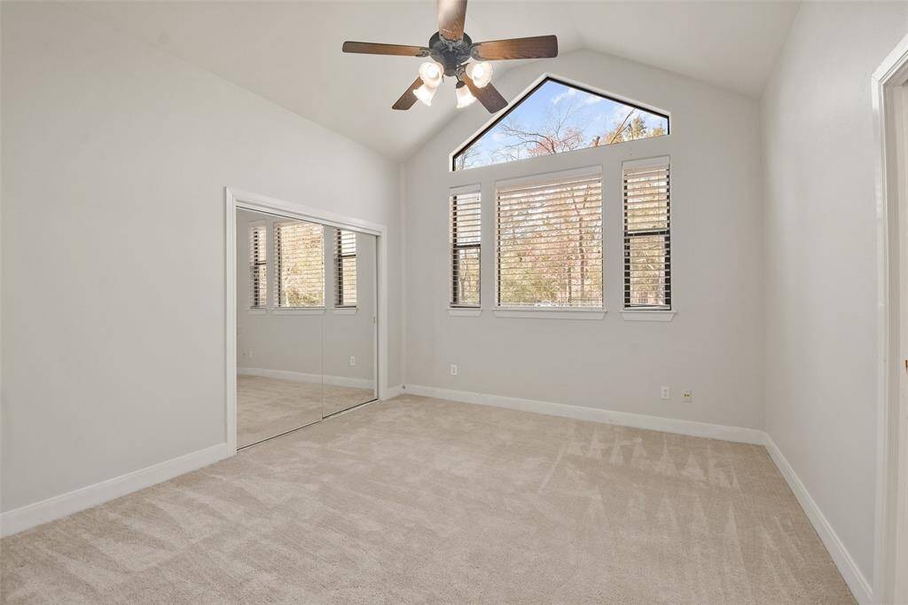 Bright & airy guest bedroom with vaulted ceilings.