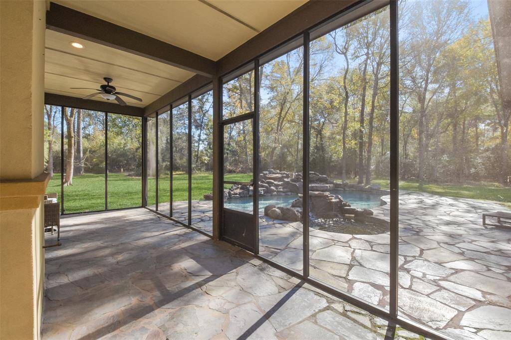 Screened-in porch overlooks the beautiful backyard & can be enjoyed year-round.
