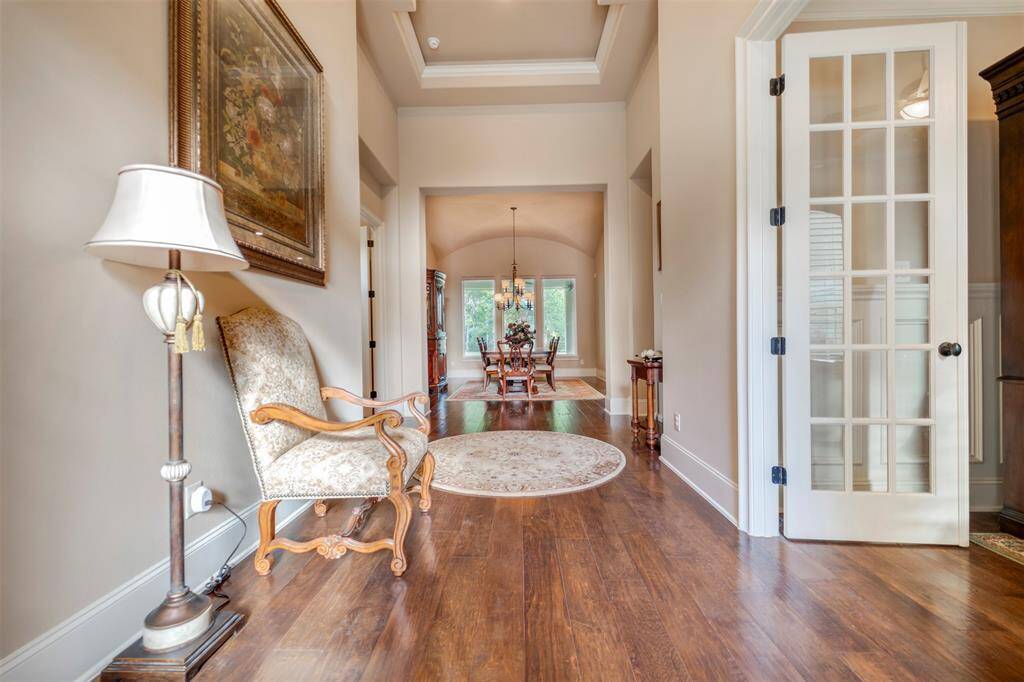 Formal entry is gorgeous with high ceilings and views all the way to the backyard.  Stunning wood floors and tray ceilings set the tone for what's about to unfold.
