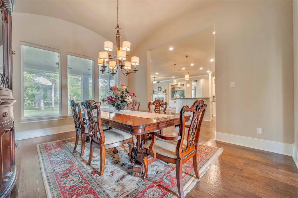 The Dining room has remarkable views from every seat.  Whether you are watching the beautiful kitchen, or peering to the backyard or admiring the front door, there is not a bad seat in this house!