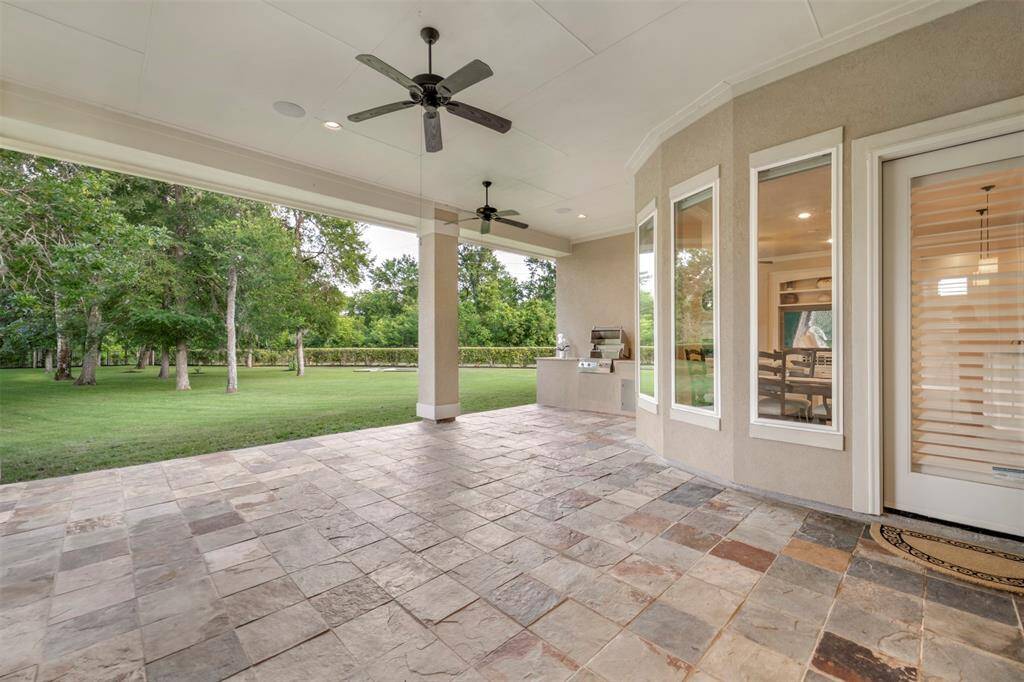 Large covered porch in the backyard is a great place for entertaining. Plenty of room for dining al fresco, and the outdoor kitchen is sparkly clean and ready for your next BBQ!